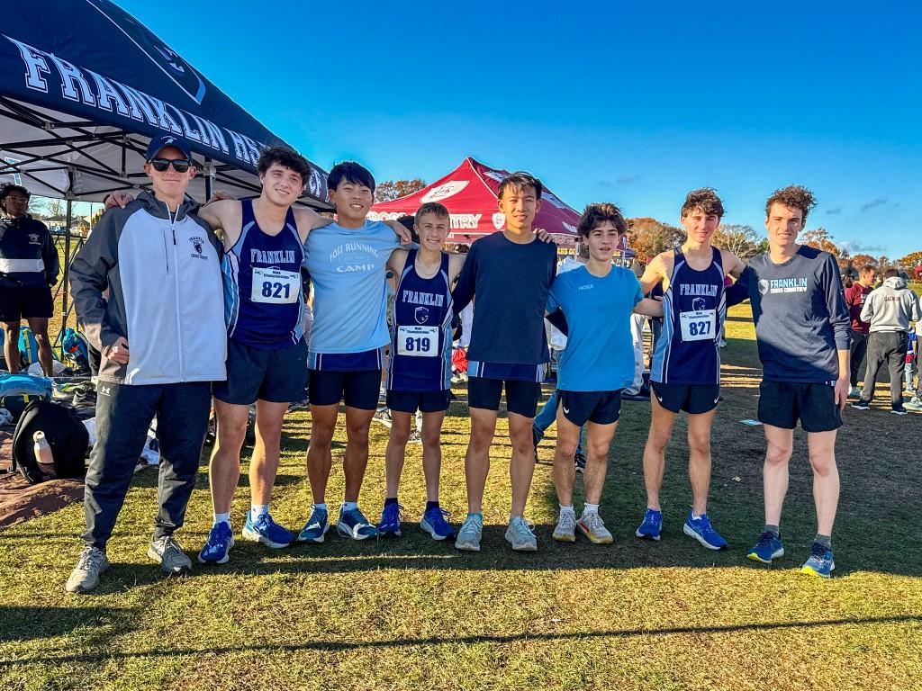 Franklin boys cross country team with their coach at a meet