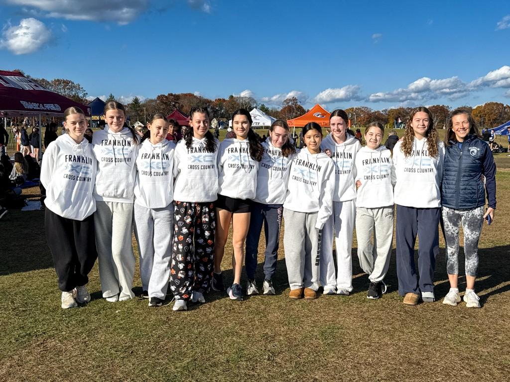 Franklin girls cross country team in Franklin XC hoodies at a meet