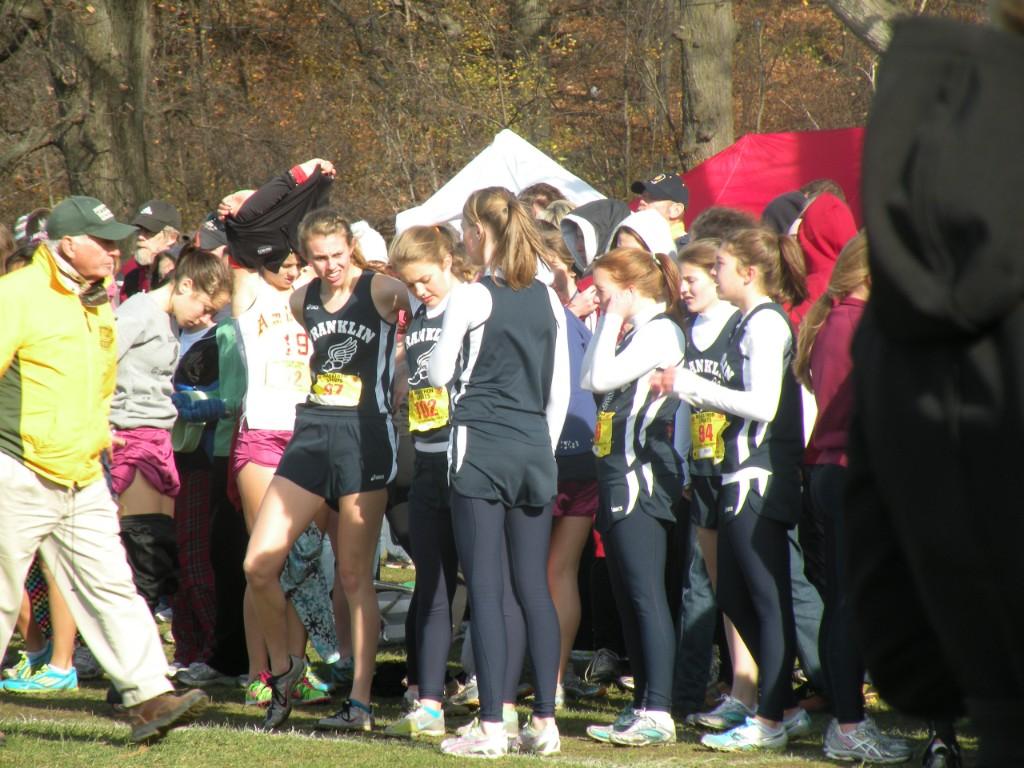 Franklin girls cross country athletes in race uniforms at a meet
